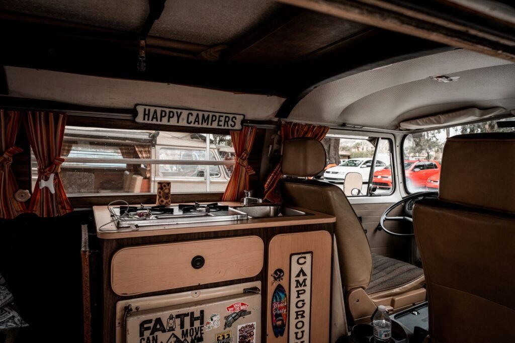 The 2026 Nissan Interstar-e Electric Camper Van parked in a forest setting at a charging station. practical detail