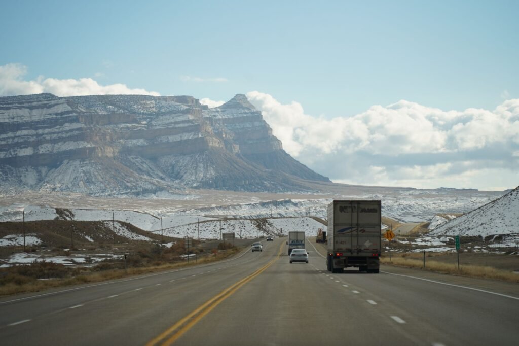 A travel trailer at a mountain pass overlook next to a 10% grade safety warning sign. practical detail