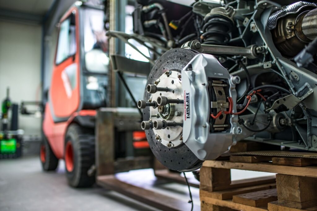 Close-up of a trailer disc brake conversion showing the rotor and hydraulic caliper on an RV axle. practical detail