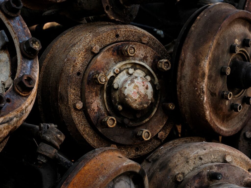 Close-up inspection of an RV axle and spindle for signs of metal fatigue and stress. practical detail