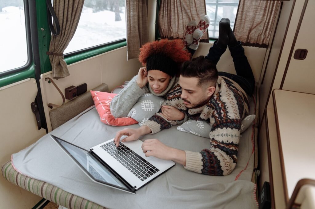 Modern travel trailer with professional inflatable winter skirting in a snowy campground. practical detail